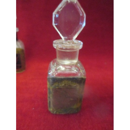 201 - SET OF THREE EARLY 20TH CENTURY FRENCH GLASS SCENT BOTTLES WITH CONTENTS AND STOPPERS:- 