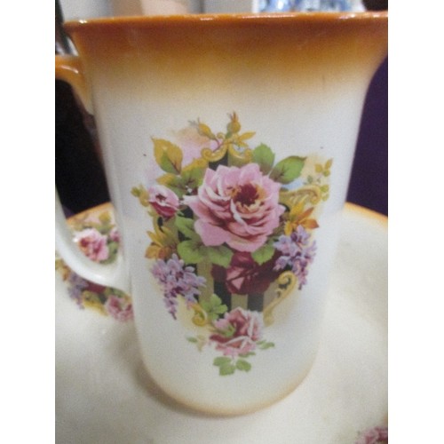 175A - A 1920'S STAFFORDSHIRE JUG AND BOWL SET DECORATED WITH PANELS OF FLOWERS & WITH A BURNT ORANGE RIM