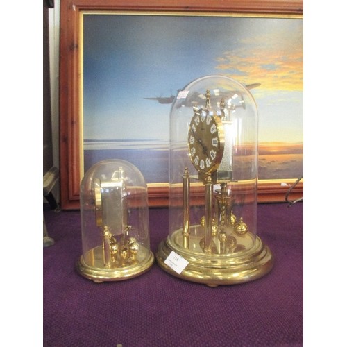 116 - ANNIVERSARY CLOCKS UNDER DOMES, A LARGE AND A SMALL. BOTH BY KUNDO GERMANY - TALLEST 29CM H.