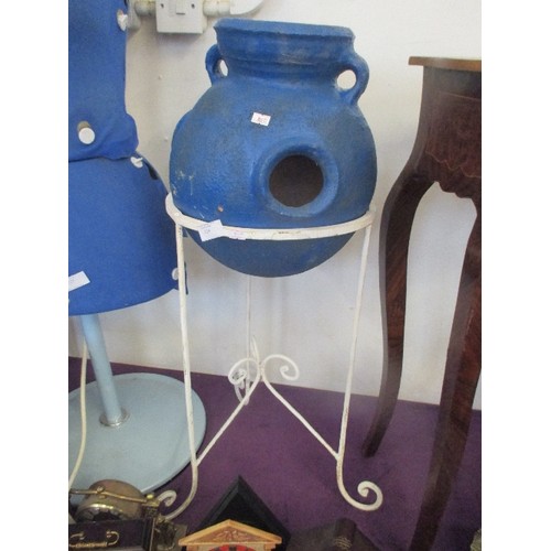 124 - RUSTIC BLUE CLAY POT WITH HANDLES. ROUND BOTTOMED, SITS ON WHITE METAL STAND.