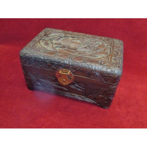 74 - HIGHLY CARVED ORIENTAL HINGED WOODEN BOX. CONTAINS HESSIAN BAG WITH TERRACOTTA AND ALSO WOODEN SYMBO... 