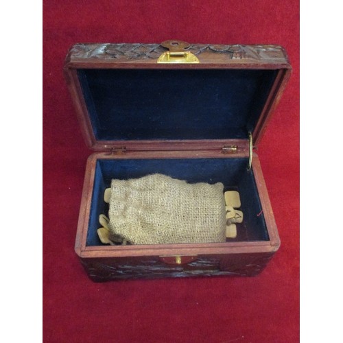 74 - HIGHLY CARVED ORIENTAL HINGED WOODEN BOX. CONTAINS HESSIAN BAG WITH TERRACOTTA AND ALSO WOODEN SYMBO... 