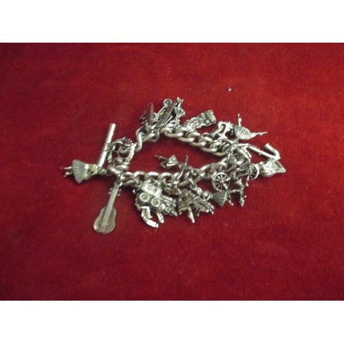 21 - HEAVY SILVER METAL CHARM BRACELET WITH CHARMS OF BALLERINA, VINTAGE CAR, STEAM TRAIN ETC