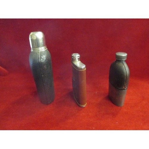 22 - THREE VINTAGE LEATHER COVERED SPIRIT FLASKS, THE LARGEST WITH STIRRUP CUP LID, A GOLFING ONE AND A B... 