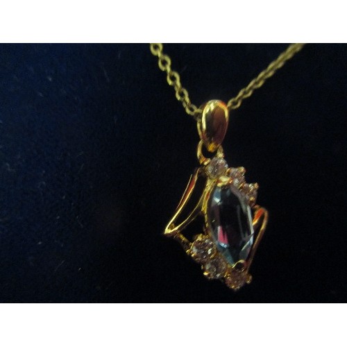 47 - A GOLD METAL PENDANT WITH AQUAMARINE COLOUR STONE FLANKED BY DIAMANTE, ON A GOLD METAL CHAIN. CHAIN ... 