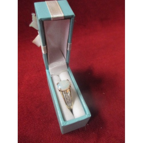 20 - A BEAUTIFUL 9CT GOLD DRESS RING WITH OPAL RAISED ABOVE A BAND OF DIAMOND CHIPS - SIZE R