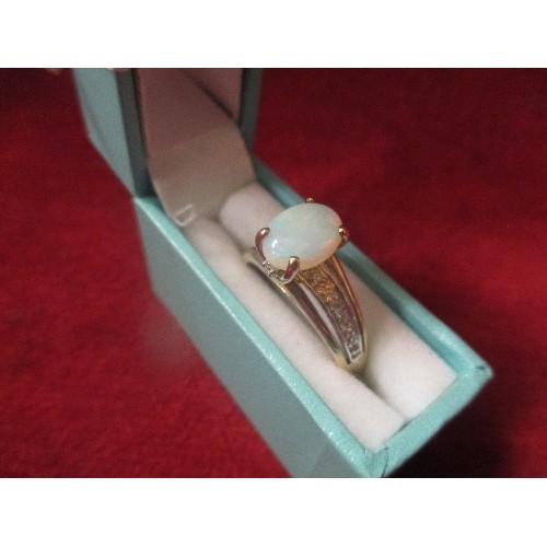 20 - A BEAUTIFUL 9CT GOLD DRESS RING WITH OPAL RAISED ABOVE A BAND OF DIAMOND CHIPS - SIZE R