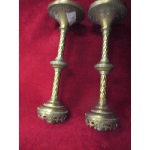 99 - A PAIR OF VINTAGE HEAVY BRASS CANDLESTICKS. POSSIBLY INDIAN.