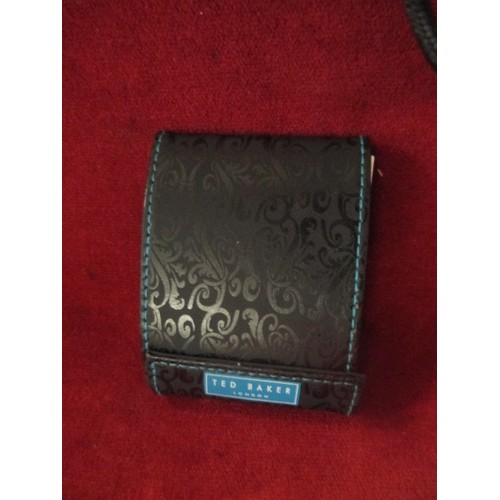 116 - TED BAKER TRAVEL CLOCK IN BLACK 'WALLET. APPEARS NEW.