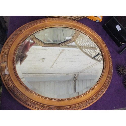 138 - 2 VINTAGE GILT FRAMED BEVELLED MIRRORS. AN OVAL AND A HEXAGONAL.