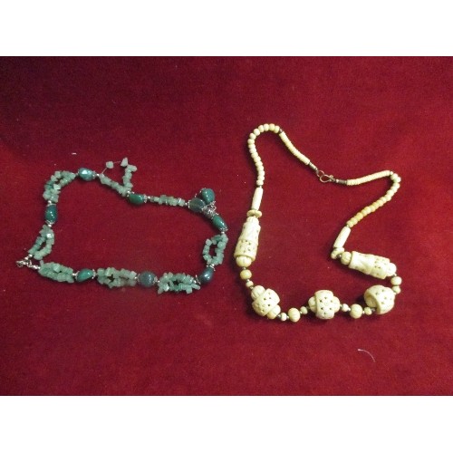 44 - AN ETHNIC STYLE BONE NECKLACE AND A GREEN GLASS BEAD NECKLACE REMINISCENT OF JADE