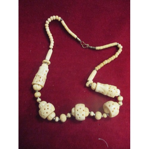 44 - AN ETHNIC STYLE BONE NECKLACE AND A GREEN GLASS BEAD NECKLACE REMINISCENT OF JADE