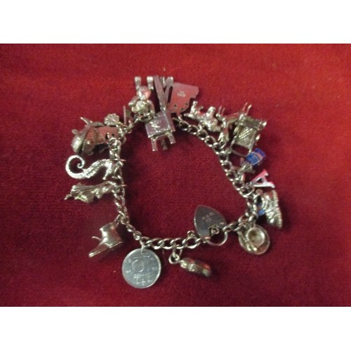 15B - A LOVELY VINTAGE STERLING SILVER CHARM BRACELET WITH APPROX 20 CHARMS - MOST WITH SILVER MARKS. SEVE... 