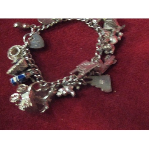 15B - A LOVELY VINTAGE STERLING SILVER CHARM BRACELET WITH APPROX 20 CHARMS - MOST WITH SILVER MARKS. SEVE... 