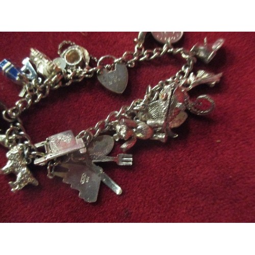 15B - A LOVELY VINTAGE STERLING SILVER CHARM BRACELET WITH APPROX 20 CHARMS - MOST WITH SILVER MARKS. SEVE... 