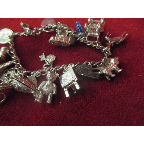 15B - A LOVELY VINTAGE STERLING SILVER CHARM BRACELET WITH APPROX 20 CHARMS - MOST WITH SILVER MARKS. SEVE... 