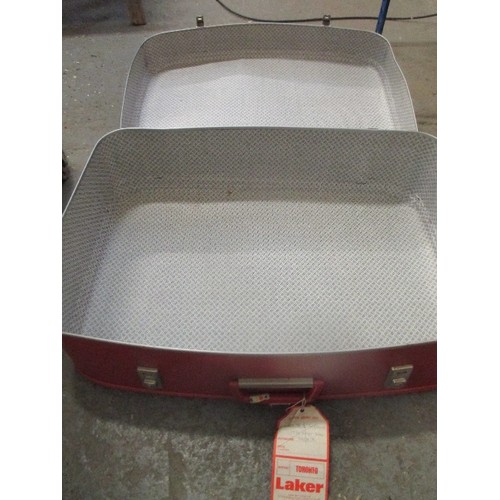 380 - LARGE BRIGHT-RED RETRO RIGID SUITCASE. LUGGAGE LABELS [TO NOTRE-DAME] STILL ATTACHED. APPROX 70CM L/... 