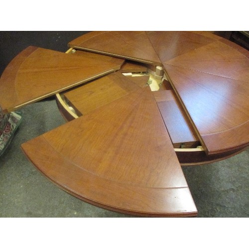 396 - A SUPERB EXPANDING CIRCULAR DINING TABLE AFTER 