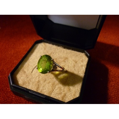 32 - 9CT WHITE GOLD RING SET WITH LARGE GREEN STONE FLANKED BY DIAMOND CHIPS - SIZE K