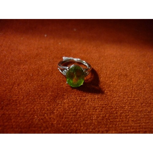 32 - 9CT WHITE GOLD RING SET WITH LARGE GREEN STONE FLANKED BY DIAMOND CHIPS - SIZE K