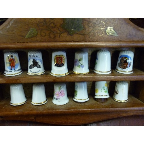 207 - THIMBLE COLLECTION, X 12 DISPLAYED ON DECORATIVE WOODEN WALL RACK.