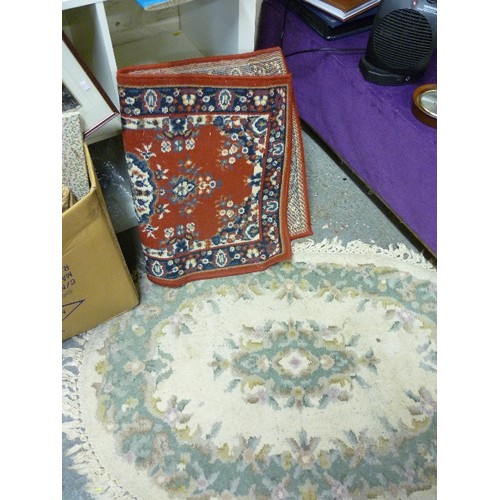 163 - 2 RUGS. A DEEP RED/NAVY/GREEN/CREAM RECTANGULAR 60 X 110CM. AND A PASTEL OVAL RUG WITH FRINGE.