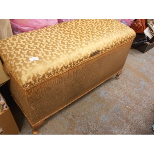 423 - VINTAGE OTTOMAN, PAINTED GOLD WITH PADDED LID IN A GOLD FABRIC.