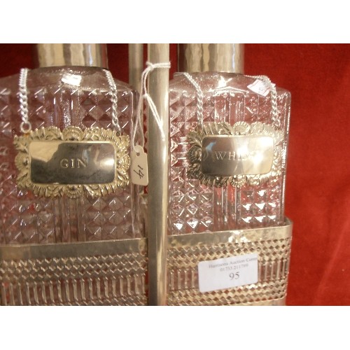 95 - PAIR OF PRESSED GLASS SPIRIT DECANTERS IN PLATED STAND WITH GIN  AND WHISKY LABELS