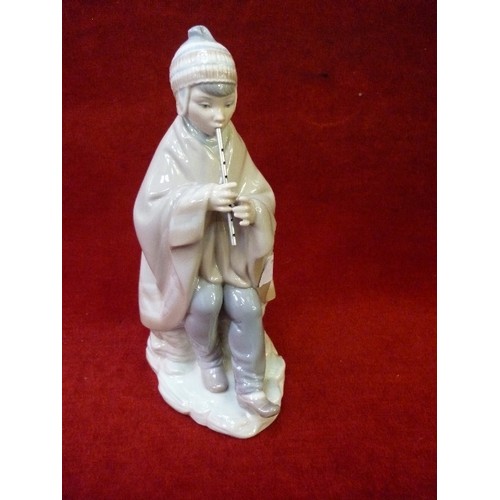 12 - A LLADRO NAO PORCELAIN FIGURE OF A FLUTE PLAYER WITH METAL FLUTE - 25CM