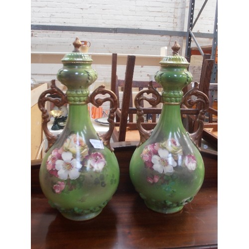 224 - A PAIR OF LATE VICTORIAN VERY LARGE EARTHENWARE VASES IN GREEN WITH PANELS OF ROSES AND WITH GILT HA... 