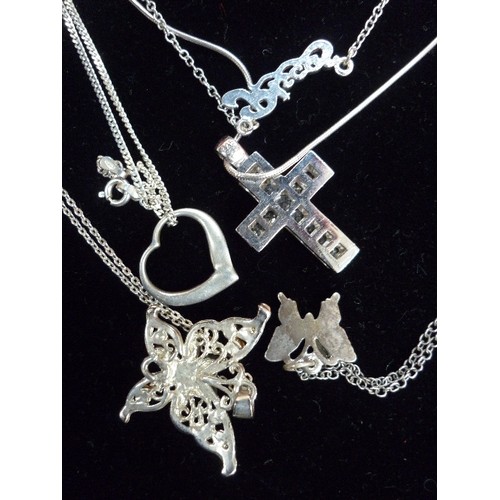 81G - 5 X 925 SILVER AND SILVER TONE NECKLACES, WITH CROSS PENDANTS, BUTTERFLIES ETC, 3 OF THEM MARKED 925... 