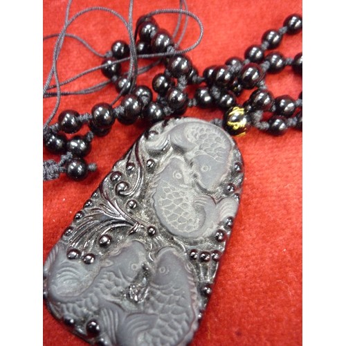 81E - AN UNUSUAL BLACK GLASS PENDANT WITH FISH DESIGN TOGETHER WITH A 