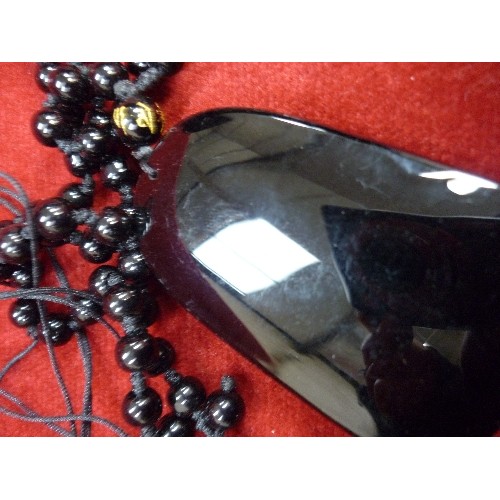 81E - AN UNUSUAL BLACK GLASS PENDANT WITH FISH DESIGN TOGETHER WITH A 