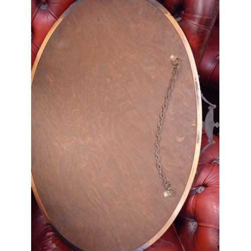 433 - A 1930'S OVAL WALL MIRROR WITH CLASSICAL URN & SWAG DESIGN - COPPER FINISH - BEVELLED GLASS