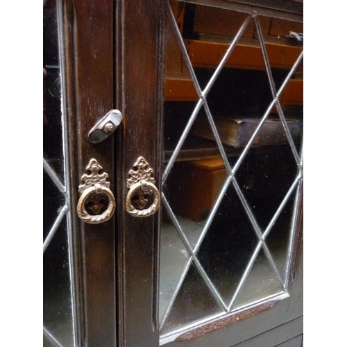 425 - A 1950'S DARK OAK BOOKCASE CABINET BY STANLEY WOOD  LTD OF OLNEY BUCKS - WITH DIAMOND LEADED DOORS -... 