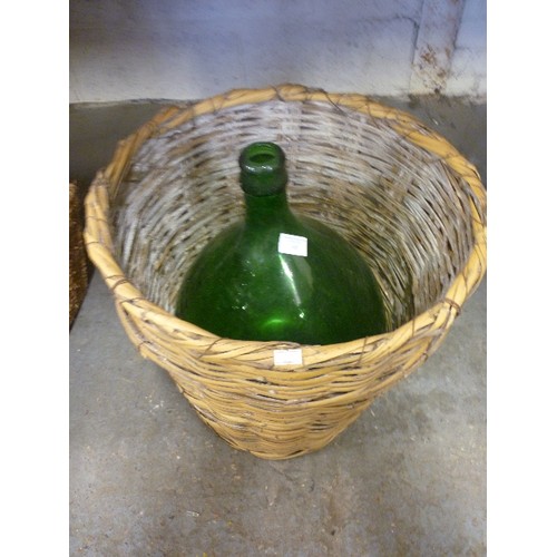 148 - LARGE VINTAGE GREEN FRENCH DEMIJOHN, IN WICKER BASKET.