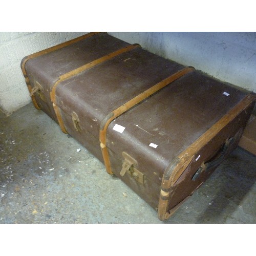 151 - LARGE VINTAGE TRAVELLING TRUNK, WITH WOODEN BANDS, BRASS CORNERS, LEATHER CARRY HANDLE EACH END.