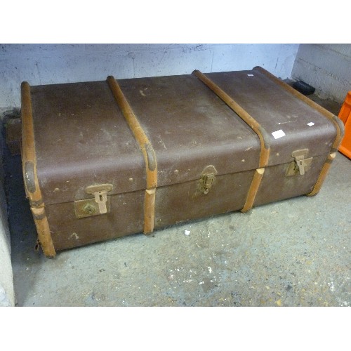 151 - LARGE VINTAGE TRAVELLING TRUNK, WITH WOODEN BANDS, BRASS CORNERS, LEATHER CARRY HANDLE EACH END.