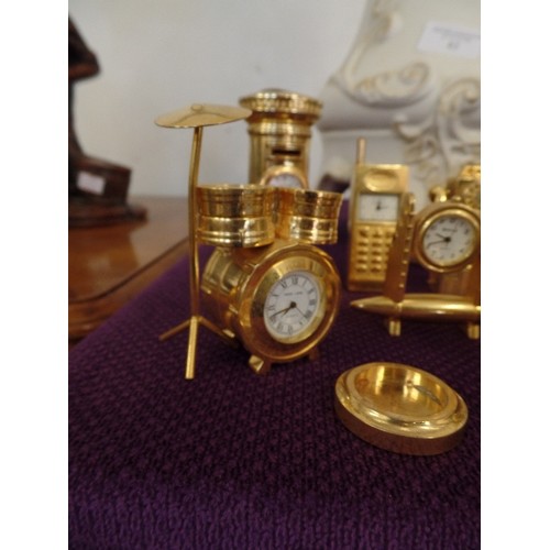 84 - COLLECTION OF 8 GILT MINIATURE NOVELTY CLOCKS - POST BOX, TELEPHONE CAMERA, DRUM KIT ETC