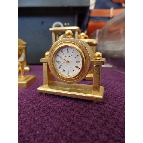 68 - A COLLECTION OF 9 MINIATURE GOLD PLATED CLOCKS