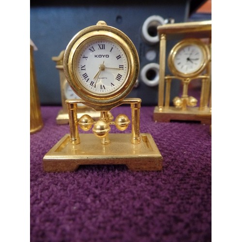 68 - A COLLECTION OF 9 MINIATURE GOLD PLATED CLOCKS