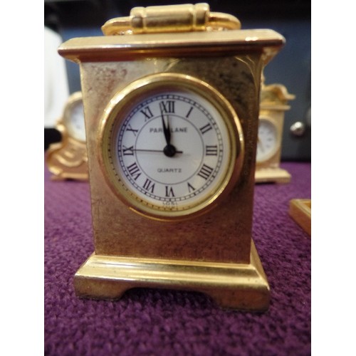 68 - A COLLECTION OF 9 MINIATURE GOLD PLATED CLOCKS