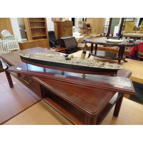 56 - MODEL PLASTIC PROPELLOR PLANE AND A LARGE MODEL OF THE TITANIC ON A WOODEN PLINTH