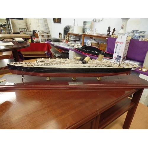 56 - MODEL PLASTIC PROPELLOR PLANE AND A LARGE MODEL OF THE TITANIC ON A WOODEN PLINTH