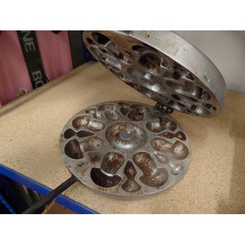 439 - CAST IRON AND WOODEN HANDLED WAFFLE IRON