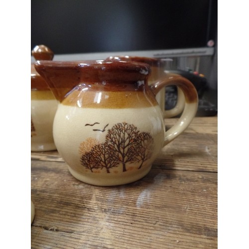 405 - POTTERY TEA SET WITH 2 EGG CUPS IN BROWNS WITH TREE DECOR