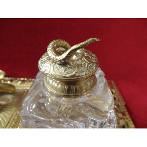 24 - A SUPERB BRASS DESK STAND WITH HEAVY GLASS INKWELLS MOUNTED WITH SNAKES. A HINGED STAMP BOX IN THE C... 