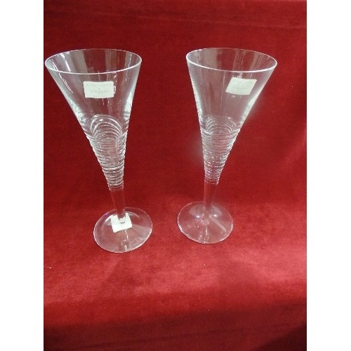 5 - A PAIR OF LARGE WATERFORD CRYSTAL CHAMPAGNE GLASSES BY JASPER CONRAN - ETCHED MARKS TO BASES - 26CM