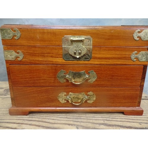 151 - AN IMPRESSIVE CHINESE HARDWOOD JEWELLERY CHEST WITH TWO DRAWERS, RED SILK LINED. BRASS FITTINGS AND ... 