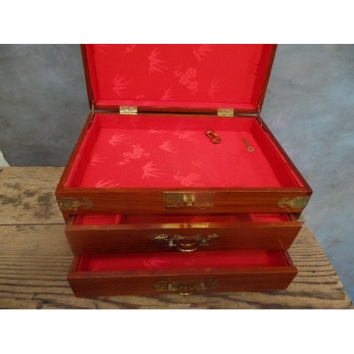 151 - AN IMPRESSIVE CHINESE HARDWOOD JEWELLERY CHEST WITH TWO DRAWERS, RED SILK LINED. BRASS FITTINGS AND ... 